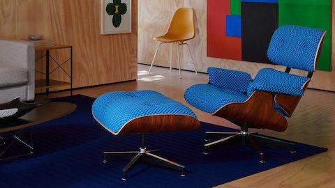 A modern living room featuring Eames Elliptical Table, Lispenard Sofa, and Eames Lounge Chair and Ottoman in a stunning Alexander Girard upholstery.