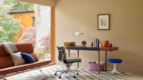 A bright home office setup featuring the Leather-Wrap by Geiger, Eames Soft Pad Chair, and Nelson Daybed.