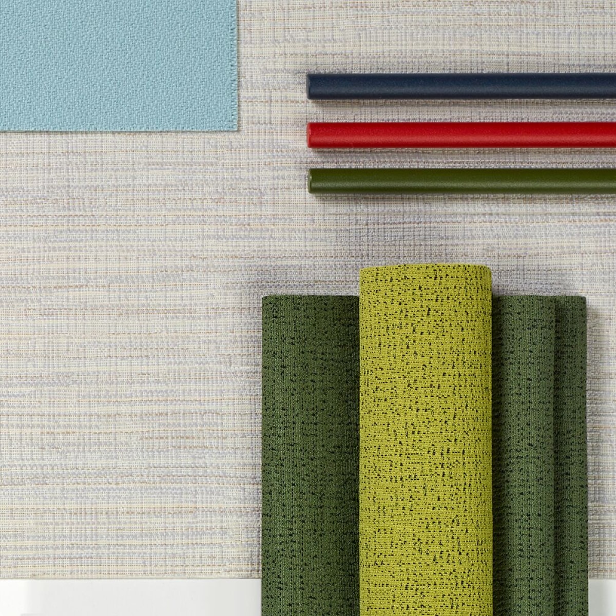 A top view of multiple, folded colorful and neutral fabrics.