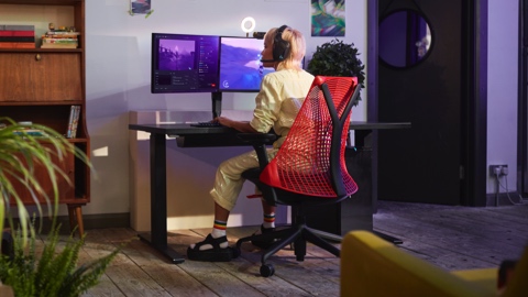 A woman sitting in a Sayl Chair in her home. A woman sitting in a Sayl Chair in her home.