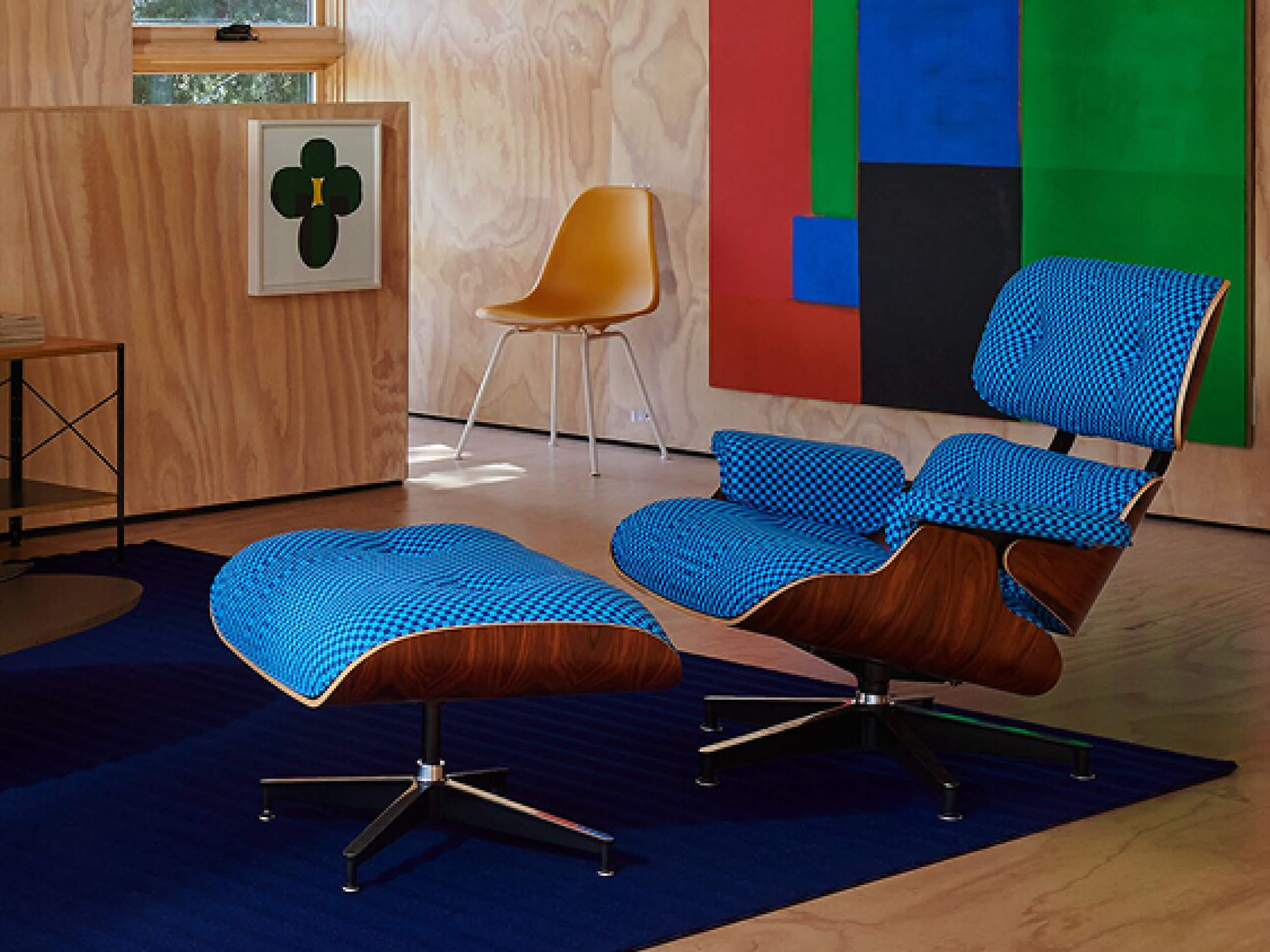 A modern living room featuring Eames Elliptical Table, Lispenard Sofa, and Eames Lounge Chair and Ottoman in a stunning Alexander Girard upholstery. A modern living room featuring Eames Elliptical Table, Lispenard Sofa, and Eames Lounge Chair and Ottoman in a stunning Alexander Girard upholstery.