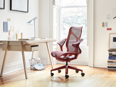 Cosm Chair in Canyon at a Distil Desk in a brightly lit home office. Cosm Chair in Canyon at a Distil Desk in a brightly lit home office.