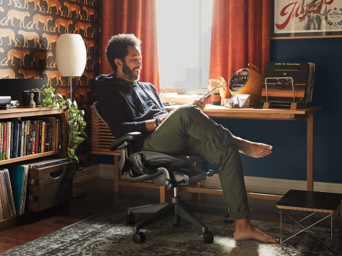 A man sitting at home in his Aeron Chair, leaning back with legs crossed. A man sitting at home in his Aeron Chair, leaning back with legs crossed.