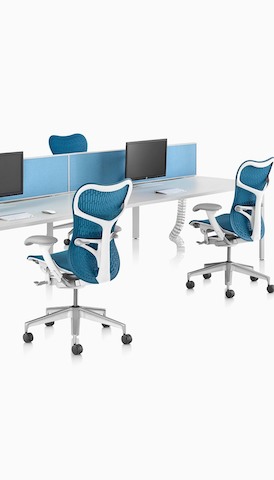 A back-to-back benching setup using white Layout Studio work surfaces and blue Mirra 2 Chairs. Select to go to the Desks and Workspaces product page.