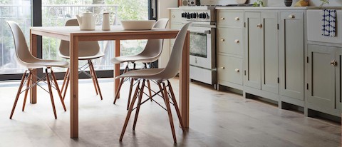 Kitchen seen in natural light featuring the Doubleframe Table in oak with four plastic Shell Chairs in stone with a dowel base. Kitchen seen in natural light featuring the Doubleframe Table in oak with four plastic Shell Chairs in stone with a dowel base.