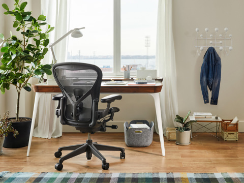Aeron Chair and Airia Desk nestled in the window corner of a living room as a makeshift home office. Aeron Chair and Airia Desk nestled in the window corner of a living room as a makeshift home office.