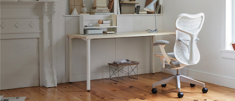White-colored Mirra 2 chair in a home office with a bookcase backdrop. White-colored Mirra 2 chair in a home office with a bookcase backdrop.