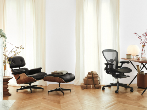 Brightly lit room with an Eames Lounge Chair and Ottoman to the left, a home office desk and Aeron Chair to the right. A pile of wrapped gifts sit in the middle. Brightly lit room with an Eames Lounge Chair and Ottoman to the left, a home office desk and Aeron Chair to the right. A pile of wrapped gifts sit in the middle.